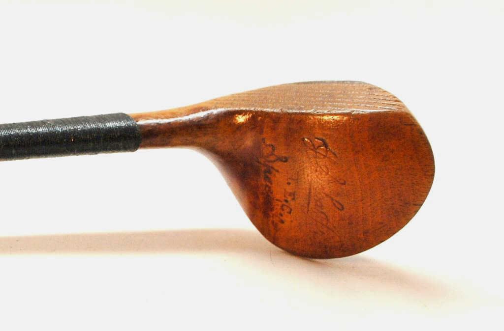 J.S. Lea Jr. Scare Neck Brassie: Marked "J.S. Lea Jr. Special" and owner initials of "H.E.C." Full Brass Sole Plate, Lead Back Weight, and Straight Line heal to toe face scoring.