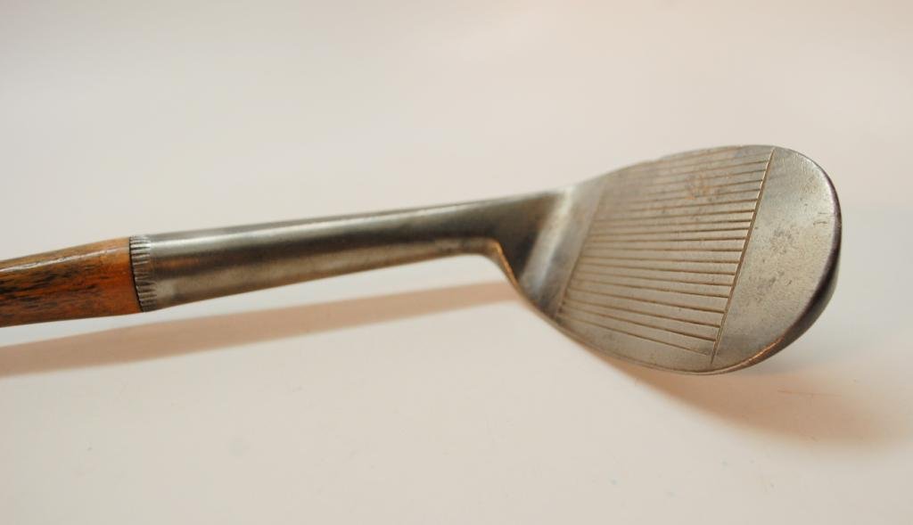 R. Forgan & Son/T. Stewart St. Andrews Niblick: R. Forgan & Son marks. Also with "Tom Stewart" registered trademark. and smoking pipe cleek mark. Narrow Line Scoring heel to toe on Face. Shaft stamped "Forgan & Son St. Andrews".