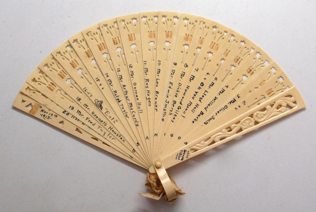 1913 Ivorine Dance Card Fan- Fiesta Party: From a Dance held Nov. 15, 1913, Dance Card Fan belonging to Misses Jeannette Elliot, with a gentleman's name written on each fan blade along with two blocked out for "eats" and down by the base "LOS 