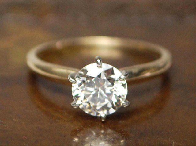 14K Gold and Diamond Solitaire Ring: Diamond Solitaire in Gold Setting, .94 carat diamond (stone recently weighed out of ring.) Round Cut Diamond set in 14K Gold Setting. Diamond Color J, Clarity SI-1. Size 4 1/2, total weight 1.9 gramsW