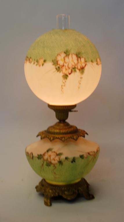 Hand-Painted Gone with the Wind Lamp: Green & White Hand-Painted Gone With the Wind Lamp with floral decoration. Slight Repair to top shade. 28" tall