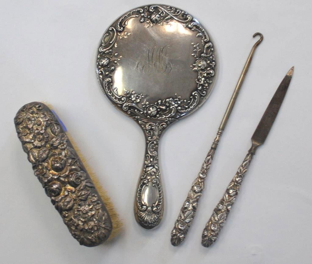 Four Sterling Silver Dresser Items: Hand Mirror, Button Hook, File and Brush