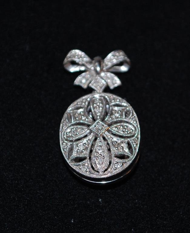 10K White Gold and Diamond Locket: 4 grams, height including bow is 1 1/4"