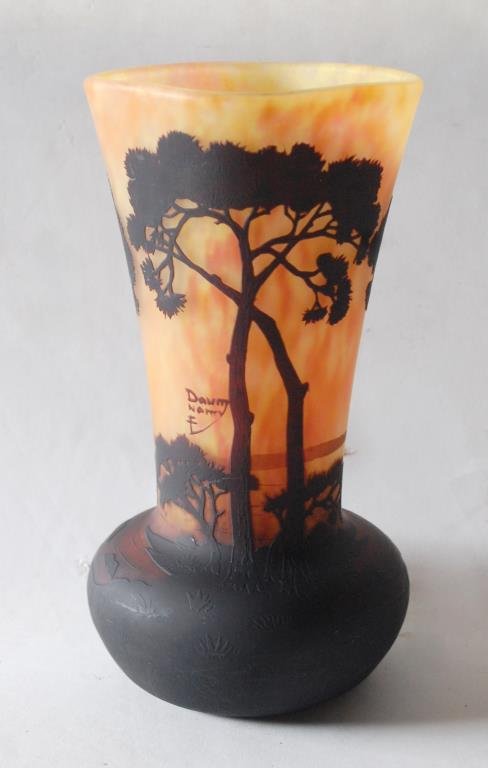 Daum Nancy Cameo Glass Vase: Image of trees along a water's edge with distant sailboats, in yellow and orange. Bulbous base with square top. Signed in cameo with Cross of Lorraine. Rounded top rim with no sharp edges. 9 1/2"Very