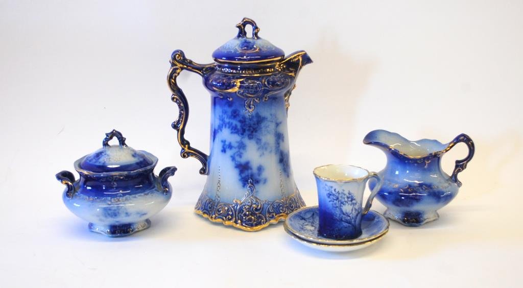La Belle Flow Blue Chocolate Pot & Set: La Belle Flow Blue Lidded Chocolate Pot, Creamer, Sugar, Two Saucers, & 2 Demitasse Cups (one not shown in photo). Pot is 10" tallAside from the crazing, excellent condition. The only issue at all is