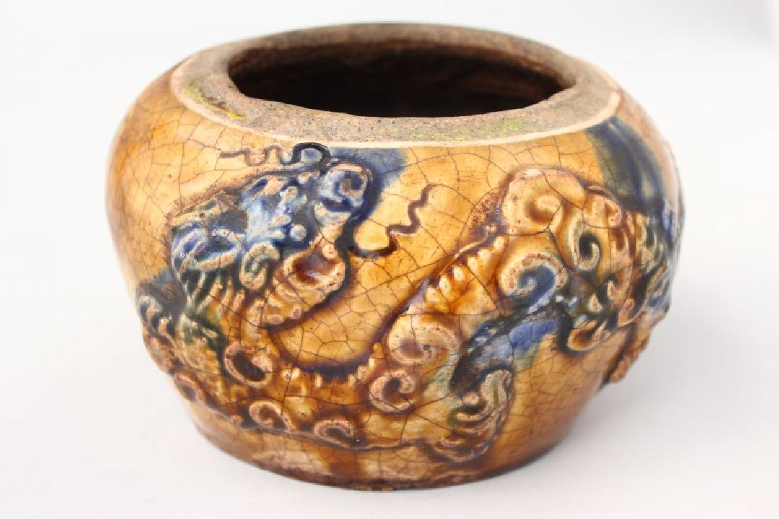 Early Chinese/ Anamese Pottery Jar,: possibly Ly /Tran Dynasty, of baluster form, decorated with raised dragon motif and flaming pearl, in a yellow and blue splashed glaze, h 17cm