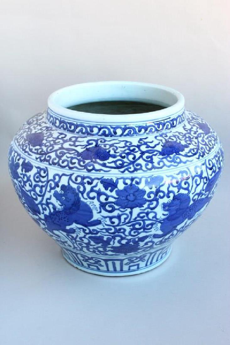 Chinese Porcelain Blue and White Jardiniere,: of baluster form, decorated with buddhist lions and peony scroll, six character mark to base, h 31cm