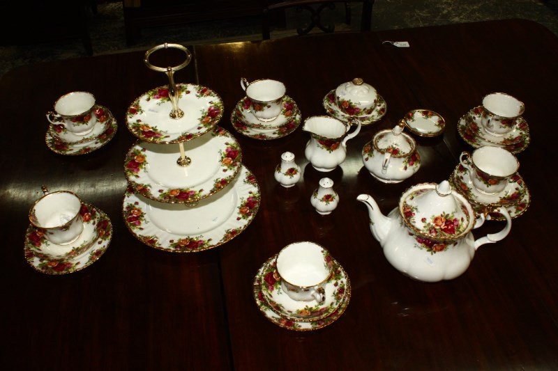 Extensive Royal Albert Porcelain Dinner Service: in"Old Country Roses", setting for six, including cups, saucers, side plates, entree pates main pates,teapot, creamer sugar bowl, salt and pepper, two dishes, and three tier cake stand, egg cups and t
