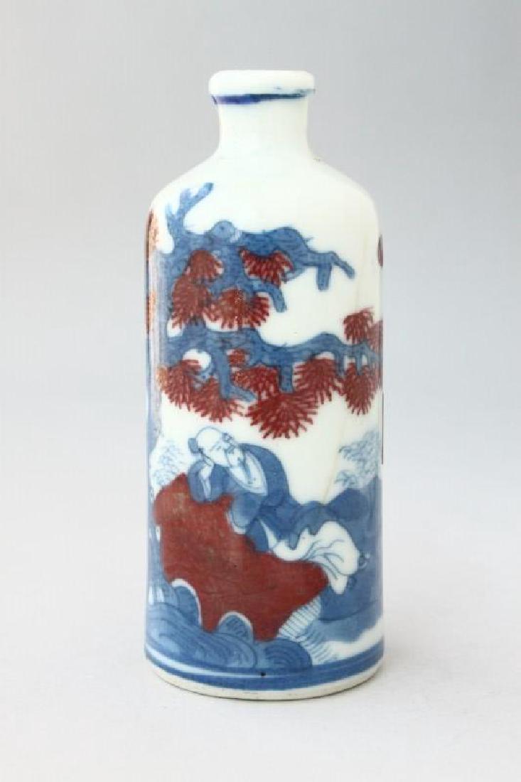 Chinese Porcelain Snuff Bottle and Stopper,: of cylindrical form, decorated with a scene of a figure reclining on a peach under a tree in iron red and blue, six character mark to base, h 8cm