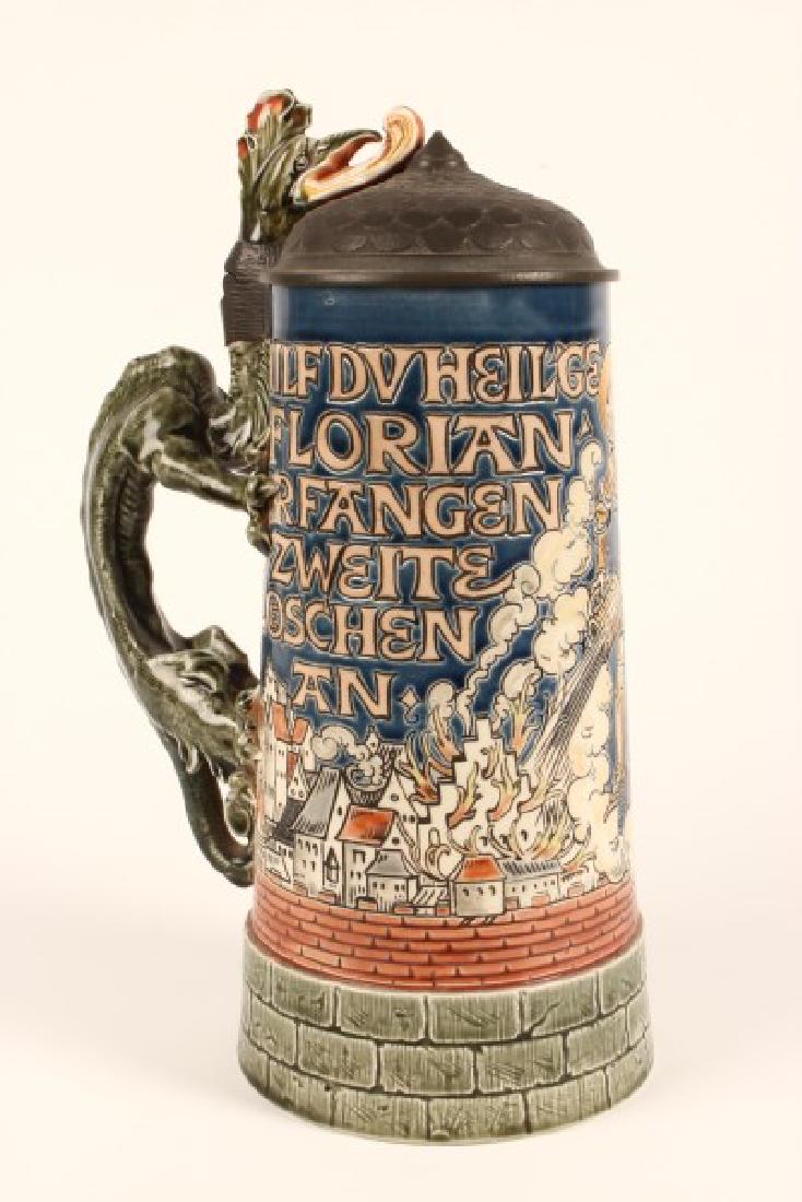 Mettlach Stoneware Ewer,: of tapering form, decorated image of a knight throwing a bucket of water on to a village that is on fire, the handle in the form of a dragon, impressed marks, h 2cm