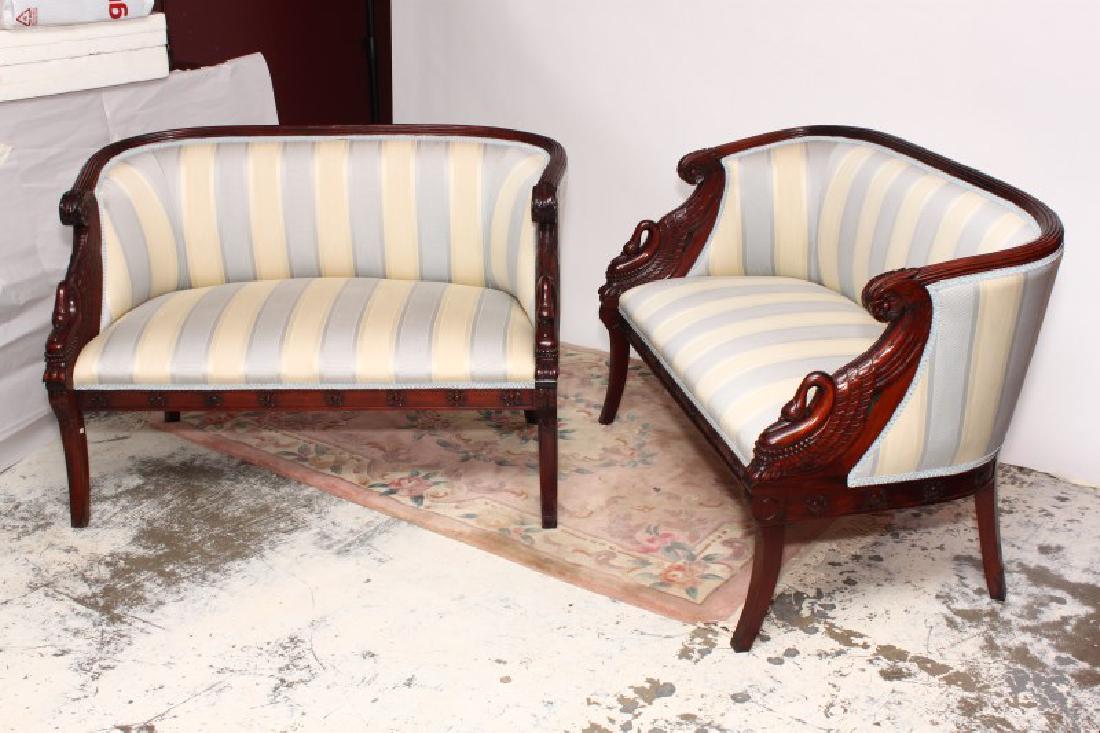 Pair of Empire Style Two Seater Settees,: with upholstered and carved reeded back, terminating to swan neck arms, above an upholstered seat, on sabre legs, striped cream and blue fabric, (2)