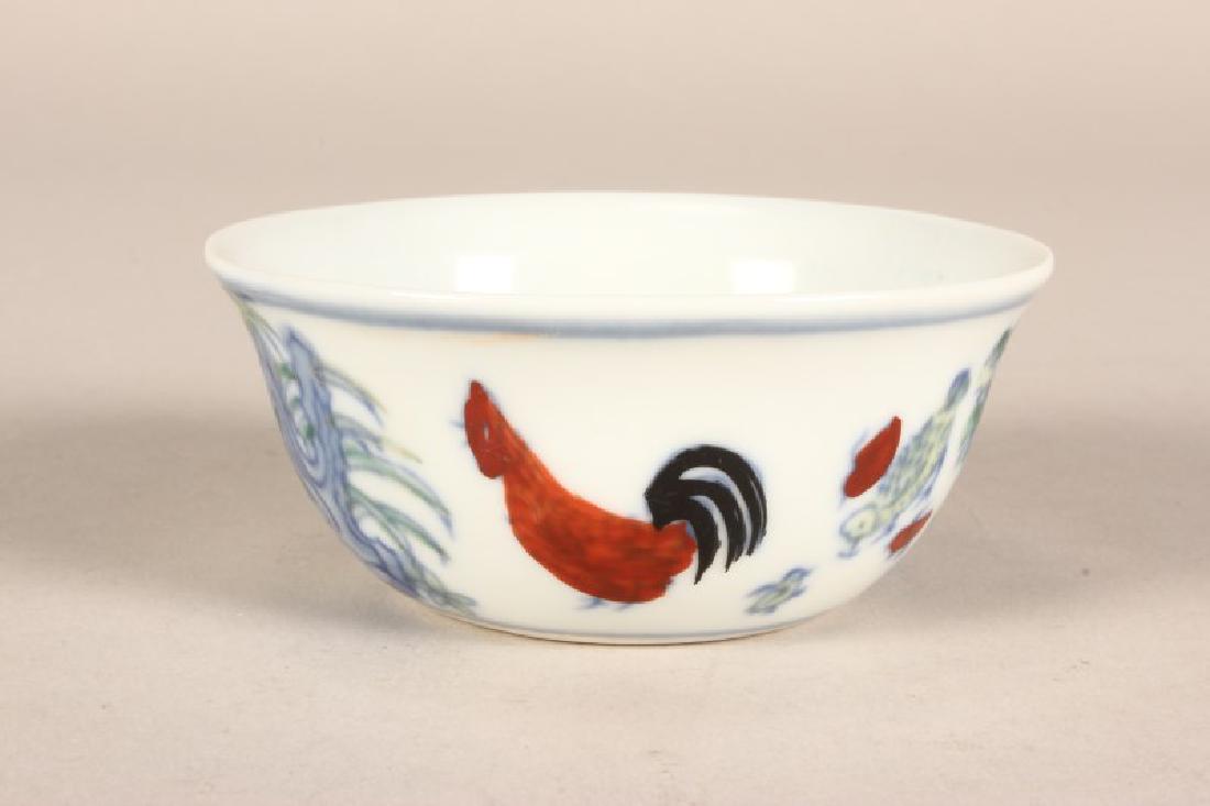 Chinese Porcelain Tea Bowl,: with flared lip, decorated with rooster, chicks and hen in tones of yellow, red and blue, six character mark to base, d 9cm