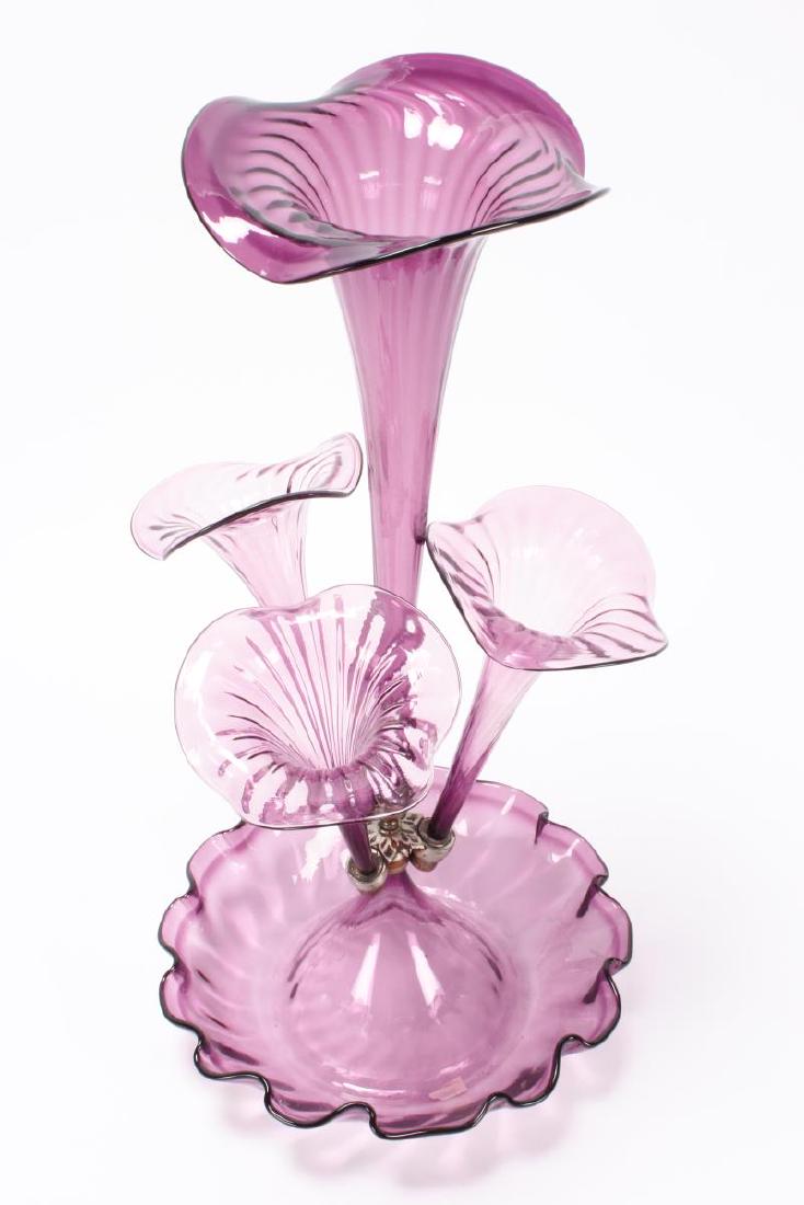 Good Victorian Purple Glass Epergne,: set with a central trumpet, flanked by three floriform trumpet vase above a lower bowl, in a purple glass, h 52cm