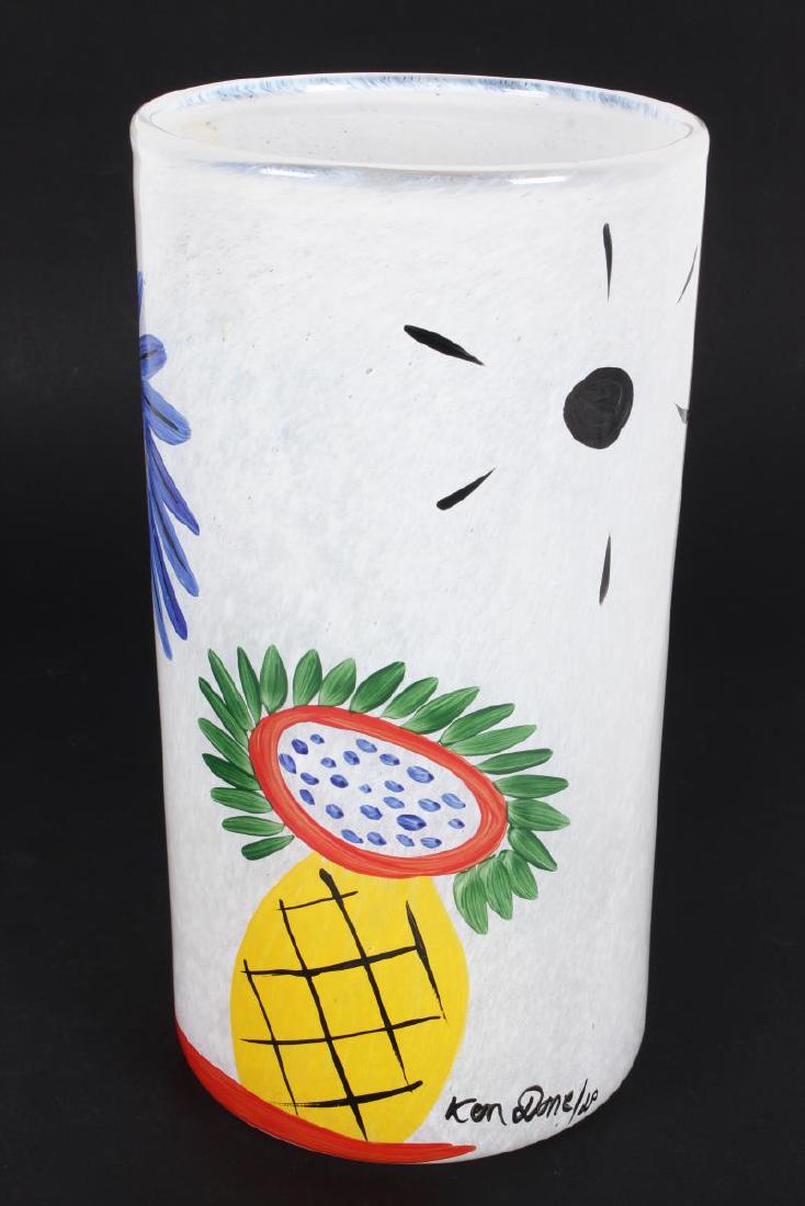 Kosta Boda Ken Done Collection Art Glass Vase,: of cylindrical form, decorated with bright tropical motifs in tones of yellow, blue, red, green and black on a mottled white base, signed and numbered to base, h 27 cm