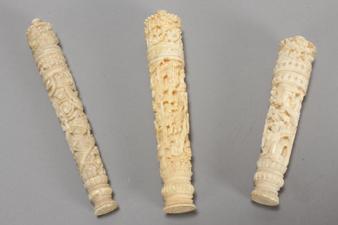Three Chinese Carved Needle Cases,: each carved with floriform cover set with finial, continuously carved with figures in a temple and floral motifs, l 7.5cm, 8.5cm and 9cm, (3)