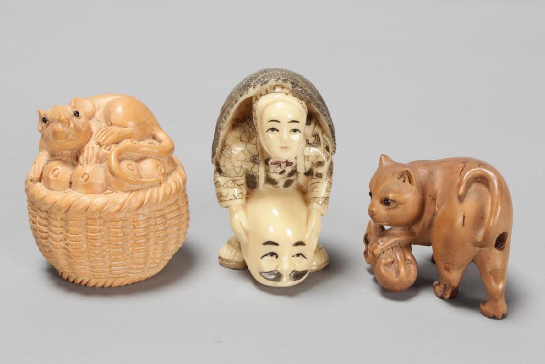 Three Carved Netsuke,: including cat with mouse, rat in basket and figure with head (3)