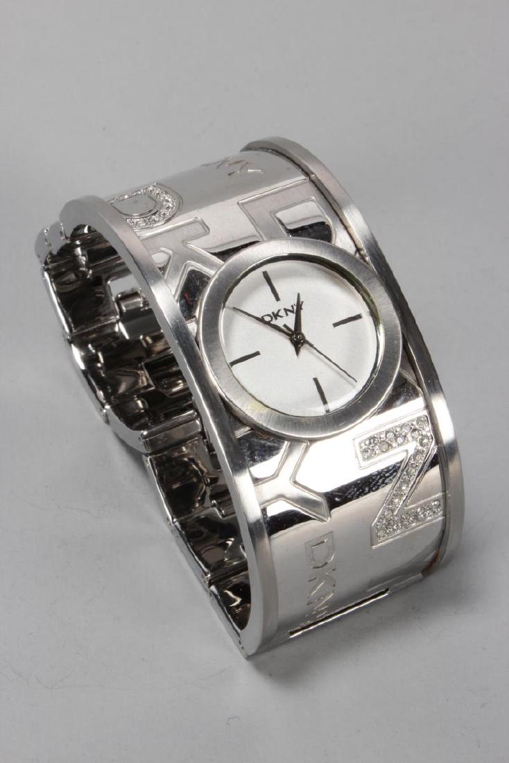 Ladies DKNY Stainless Steel Wristwatch,: with small circular dial set into wide steel band, decorated with logo and accented with diamantes, with box