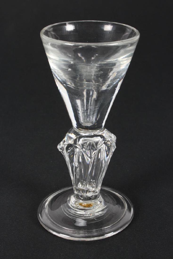 Georgian Silesian Stem Dram Glass,c.1735,: with funnel shaped bowl, on a pedestal Silesian stem on circular folded foot, h 11cm Provenance: A number of pieces of the collection featured in the 'Circle of Glass Collectors Commemorative Exhibiti