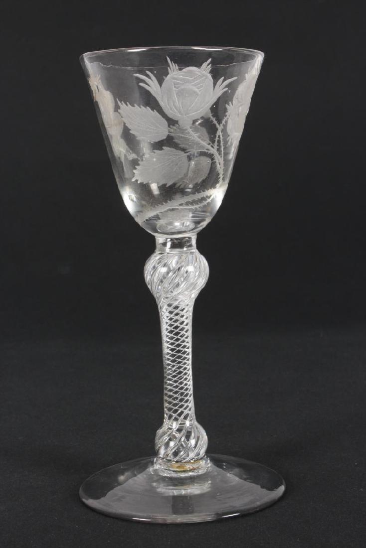 Georgian Jacobite Engraved Wine Glass, c.1745,: with round funnel shaped bowl, engraved with rose, flower bud and oak leaf representing Jacobite sympathies, raised on knop air twist stem, on circular foot, with Phillips label, h 15cm Provenance: A 