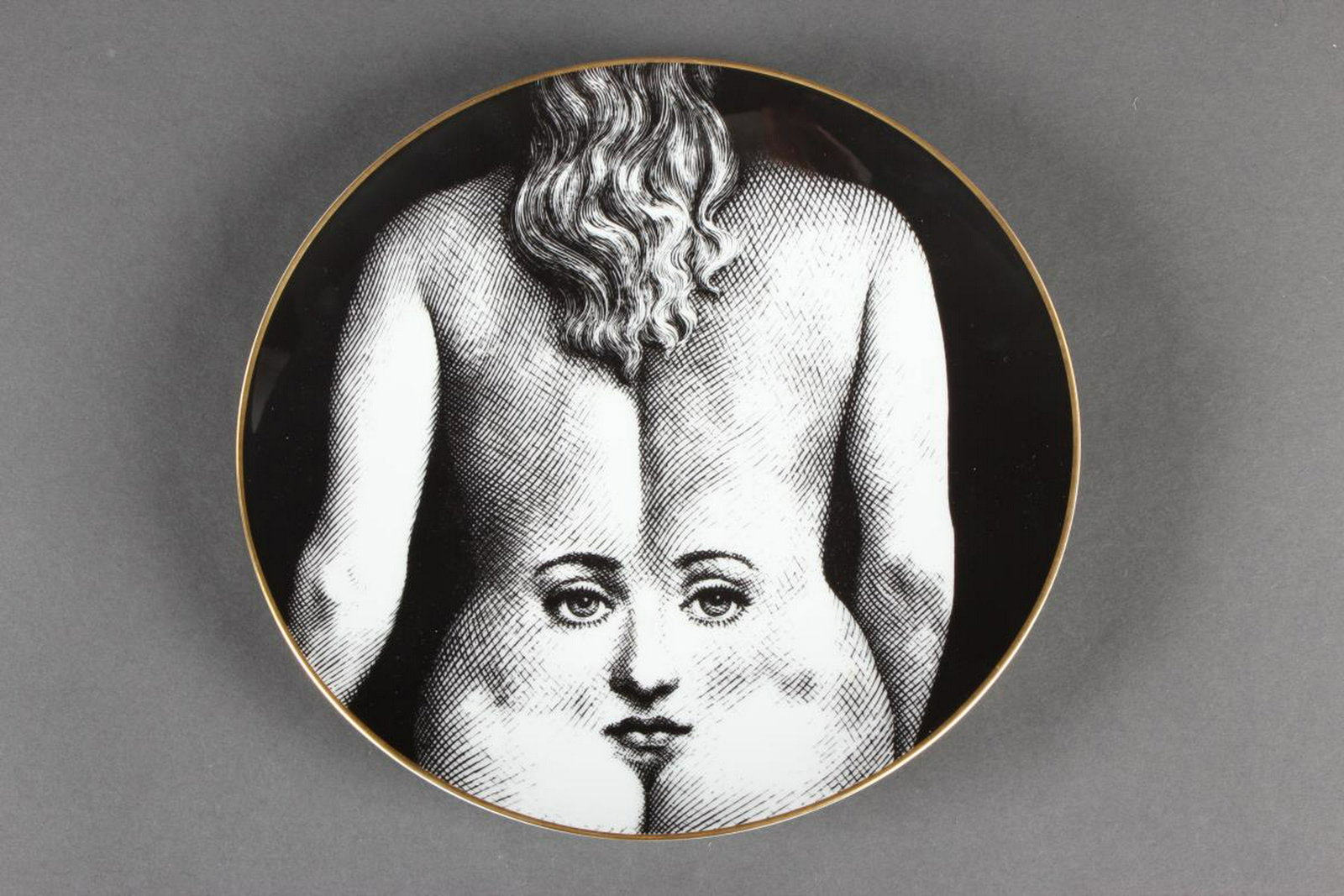 Piero Fornasetti "Julia" Plate for Rosenthal,: Temi e Variazioni Motiv #28, of circular form, decorated with the back of a woman with a face appearing on it, in black and white, printed factory marks, d 23.5cm