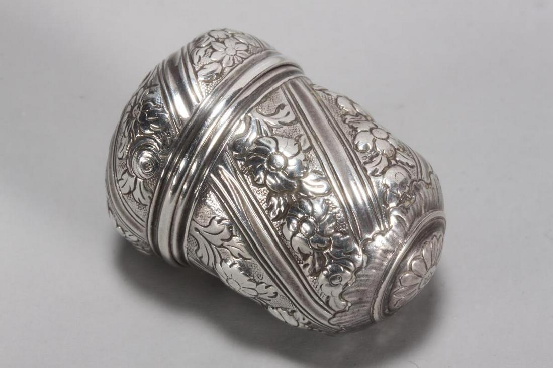 George III Sterling Silver Nutmeg Grater,: unmarked, maker Daniel Field, c.1760, of acorn form, embossed with central flower to top and bottom, surrounded by alternating bands of fluting and flowers, the lid unscrewing to reveal a removable ra