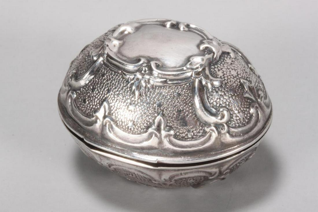 Large Victorian Repousse Silver Nutmeg Grater,: unmarked, c.1847, in the form of a nutmeg, with hinged cover opening to reveal a hinged grater, decorated with blank cartouche to either side, surrounded by foliate motifs, total weight 27gm, h 3.5cm