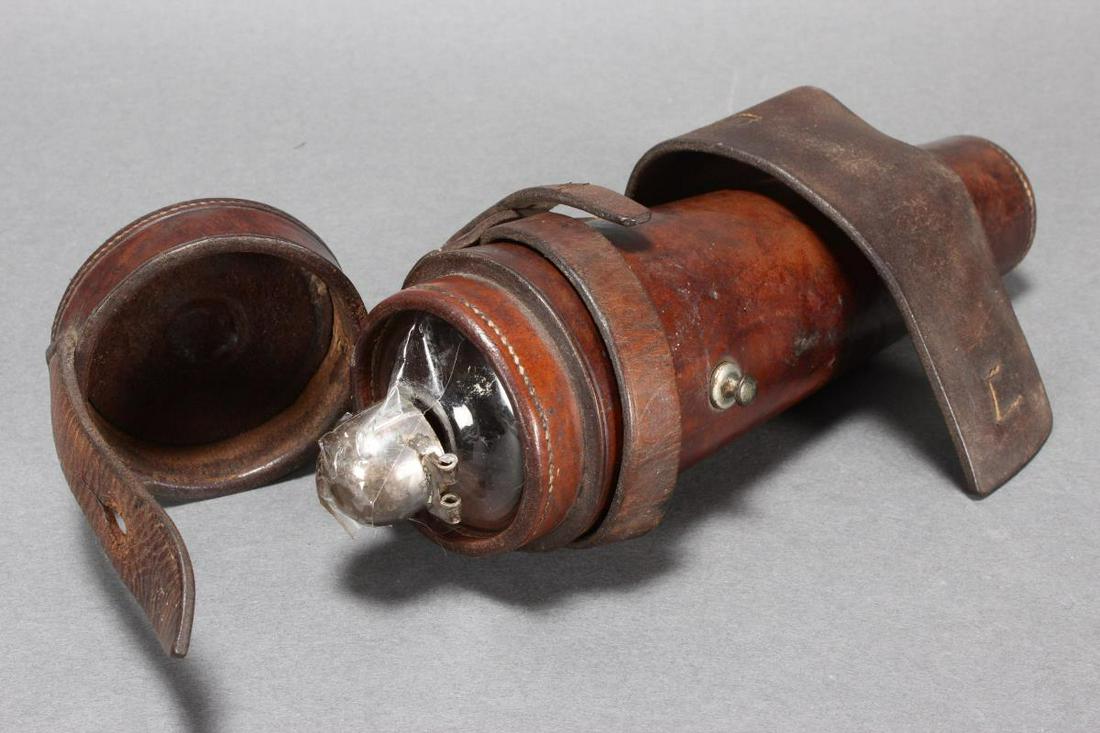 Victorian Saddle Flask,: set with a domed cover above a tapering glass flask, set within a leather case, l 24cm