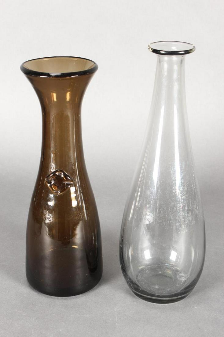 Holmegaard Style Glass Carafe,: in green glass, h 29cm, together with another clear glass bottle vase, h 32cm (2)