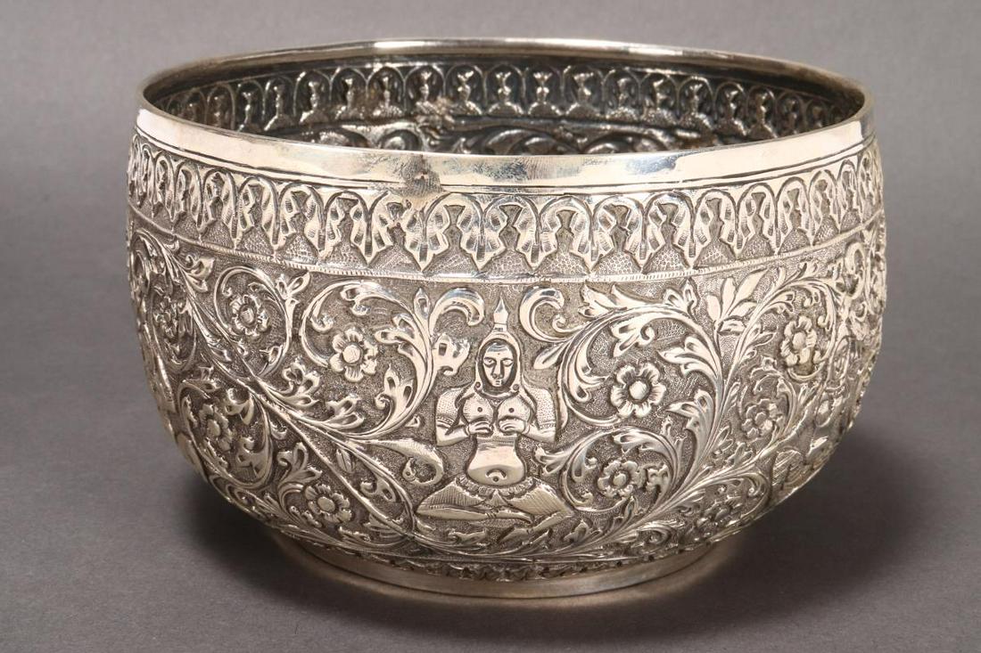 Burmese Silver Bowl,: of deep circular form, heavily embossed with deities, acanthus and floral motifs, double peacock mark to base, a/f, total weight 278gm, h 9cm and d 15cm
