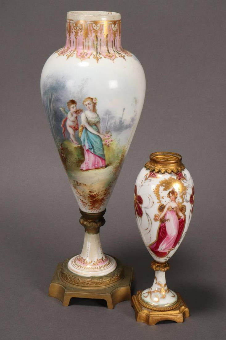 Two Continental Porcelain Urns on Stands,: both of tapering form, one decorated with lady and cupid within a garden setting, with ormolu mounts, the other decorated with a lady in art nouveau taste, h 36.5cm (2)