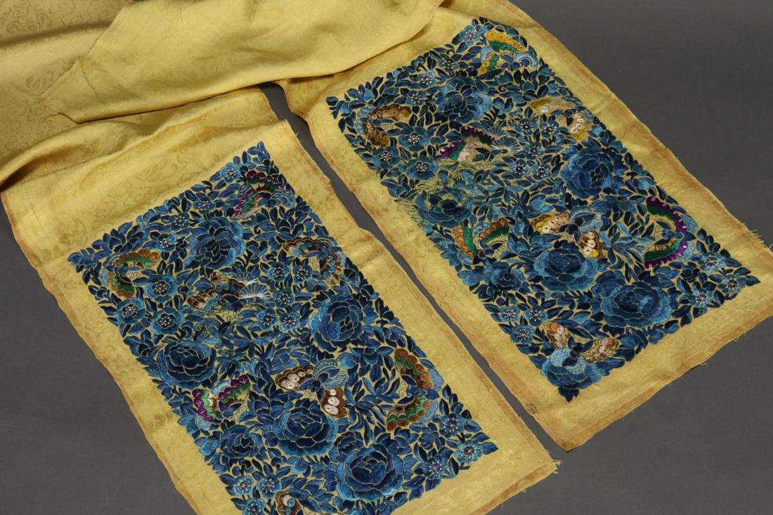 Pair of Chinese Late Qing Embroidered Skirt Panels: heavily decorated with butterflies and peonies, in tones of blue, brown, green and white on a pale yellow silk damask ground, 70cm x 23cm