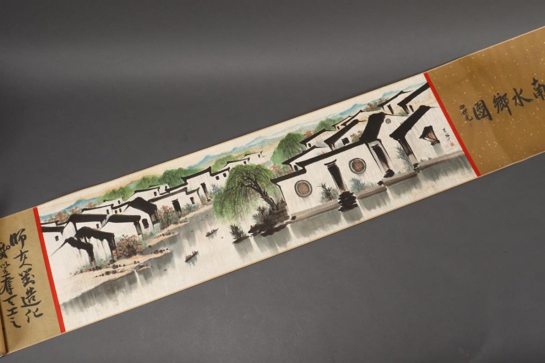 Extensive Chinese Scroll,: of horizontal format, decorated with a village scene by a river, in tones of black, white and green, signed centre right, 308cm x 30cm (image)