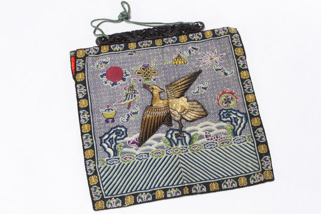 Pair of Chinese Qing Dynasty Military Rank Badges,: of square form with central Mandarin duck in gold thread, with fret background and Buddhist symbols and turbulent waves, with bat and shou border, in tones of blue, yellow, green and orange, 28cm x 29