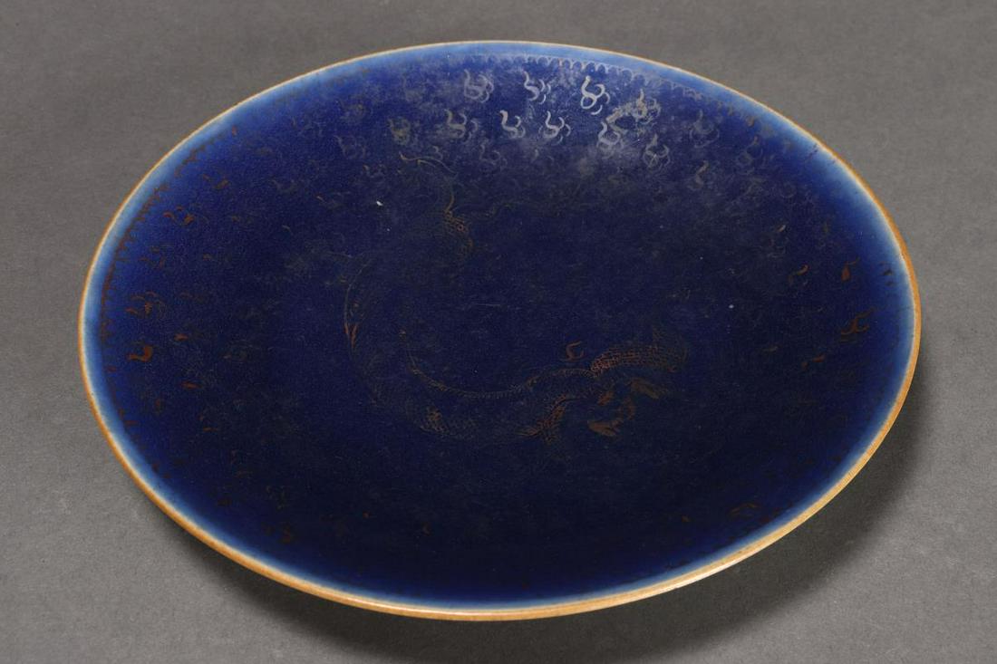 Chinese Tao Kuang Period (1821-1850) Porcelain: Plate, of circular form, decorated with a central gilt dragon surrounded by cloud scrolls in gilt (rubbed), on a cobalt ground, on a circular foot, seal mark and wax export seal to base, diameter 20cm