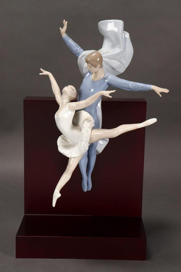 Large Lladro Porcelain Figure Group,: depicting a male and female ballet dancer in full flight, in soft tones of blue and white, signed and numbered no.549 verso, height 46cm (including stand)