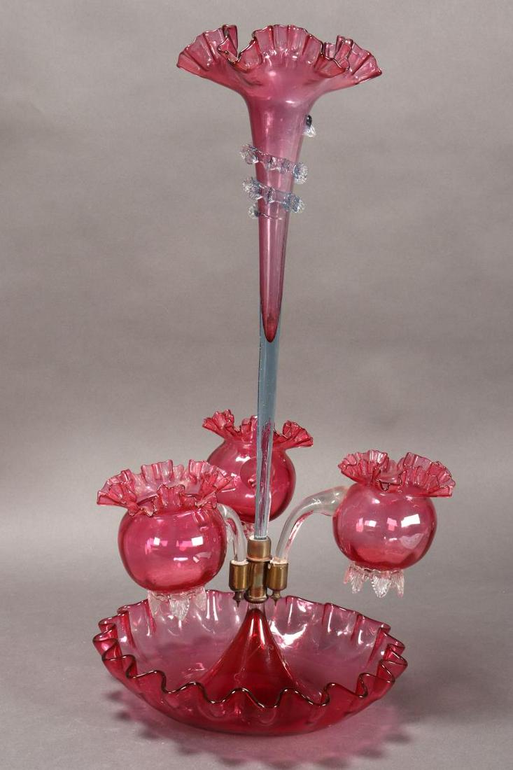 Victorian Ruby Glass Epergne,: with central flute with pinched rim, with three bulbous baskets below, the whole set within a ruby glass bowl with a pinched rim, total height 52cm