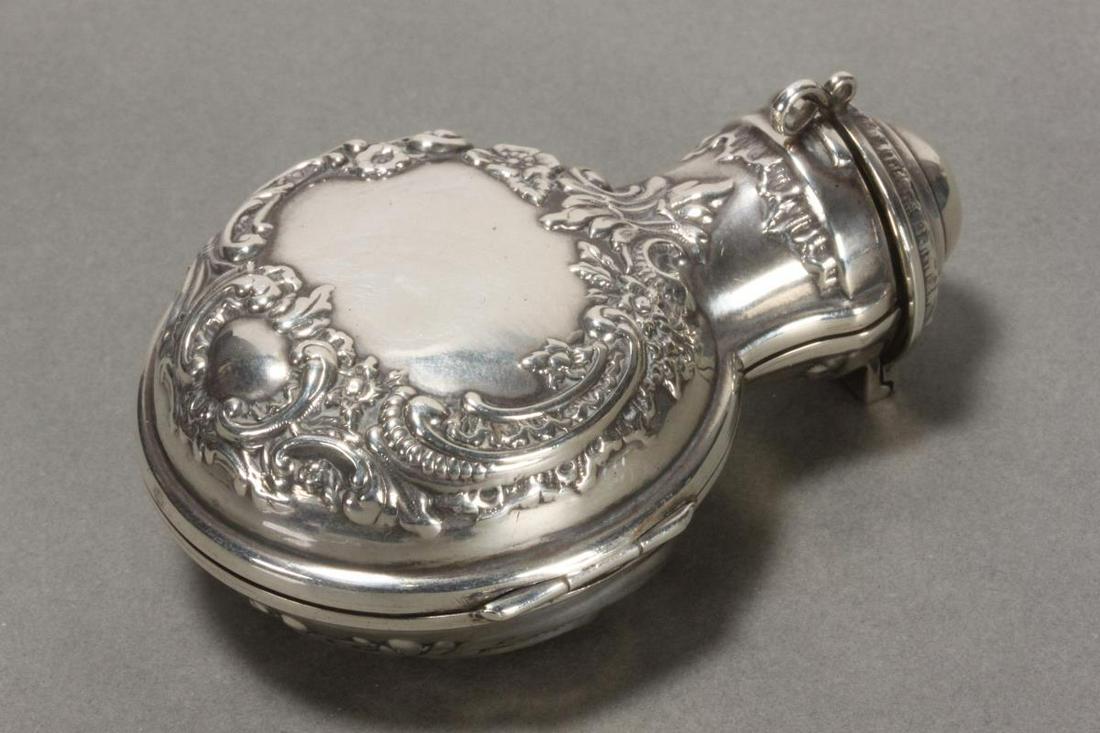 Edwardian Sterling Silver Scent Bottle Holder and: Scent Bottle, the case hallmarked, London, 1900, W.A (Walker & Hall), of pilgrim form embossed with scrolls and flowers, height 7cm