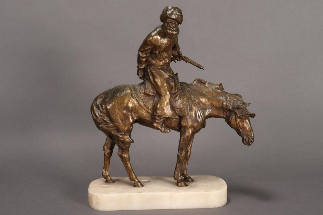 René Paris (French, 1881-1970) Bronze Sculpture,: depicting a Russian Cossack seated on horseback holding a rifle in one hand and bearing to one side, raised on a white marble base, signed to marble, height 43cm