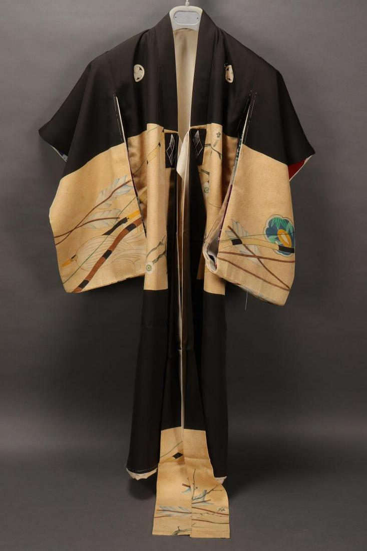 Japanese Christening Gown of Tokugawa Yoshinobu,: (The Last of Tokyo Shoguns) 1837-1913, beautifully decorated with bows, arrows, tsubas, prunus blossom and a samurai helmet to back, on a cream and gold speckled ground, the shoulders bearing the Toku
