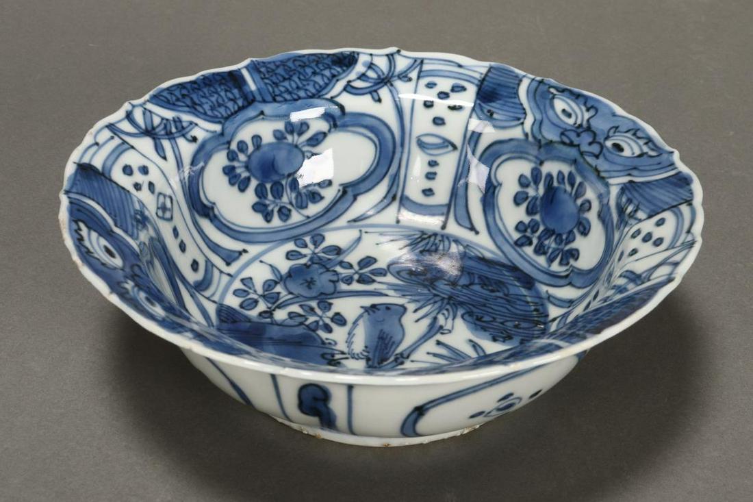 Chinese Qing Dynasty Blue and White Porcelain Bowl: with a spreading serpentine edge, decorated with a central bird in tree, surrounded by panels of peaches and flowers, on a circular foot, diameter 15cm Provenance: Leonard Joel, then Private Collectio