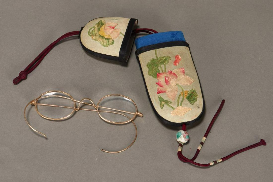 Chinese Waist Hung Spectacle Case with Spectacles,: the silk case with applique lotus flowers, in tones of pink and green (2) Provenance: Collection of Genevieve Cummins Published: Genevieve Cummins & Nerylla Taunton, Chatelaines: Utility to Glorious E