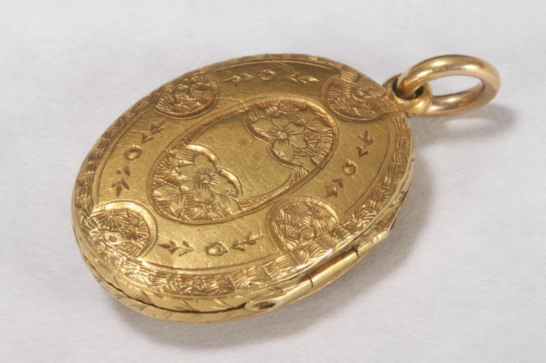 Victorian Yellow Gold Locket,: of oval form, featuring a central seed pearl set within a blue enamel multi pointed star, with incised tooling to borders and foliate designs to verso, the locket opening to reveal a small watercolour