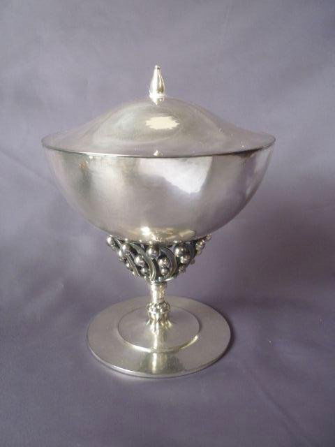 Georg Jensen Sterling Silver Covered Comport,: c.1950, designed by Johan Rohde, with a domed cover and finial above a tapering bowl, with a slightly beaten finish resting upon a stylised leaf and berry support on a stepped circular base, no:43, h