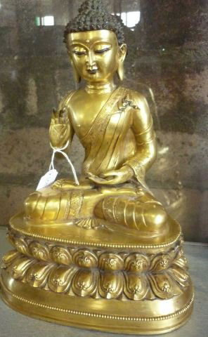 Chinese Gilt Bronze Buddha,: depicted seated with legs crossed with hand in lap and the other raised, seated on a double lotus base, six character mark to base, h 30cm