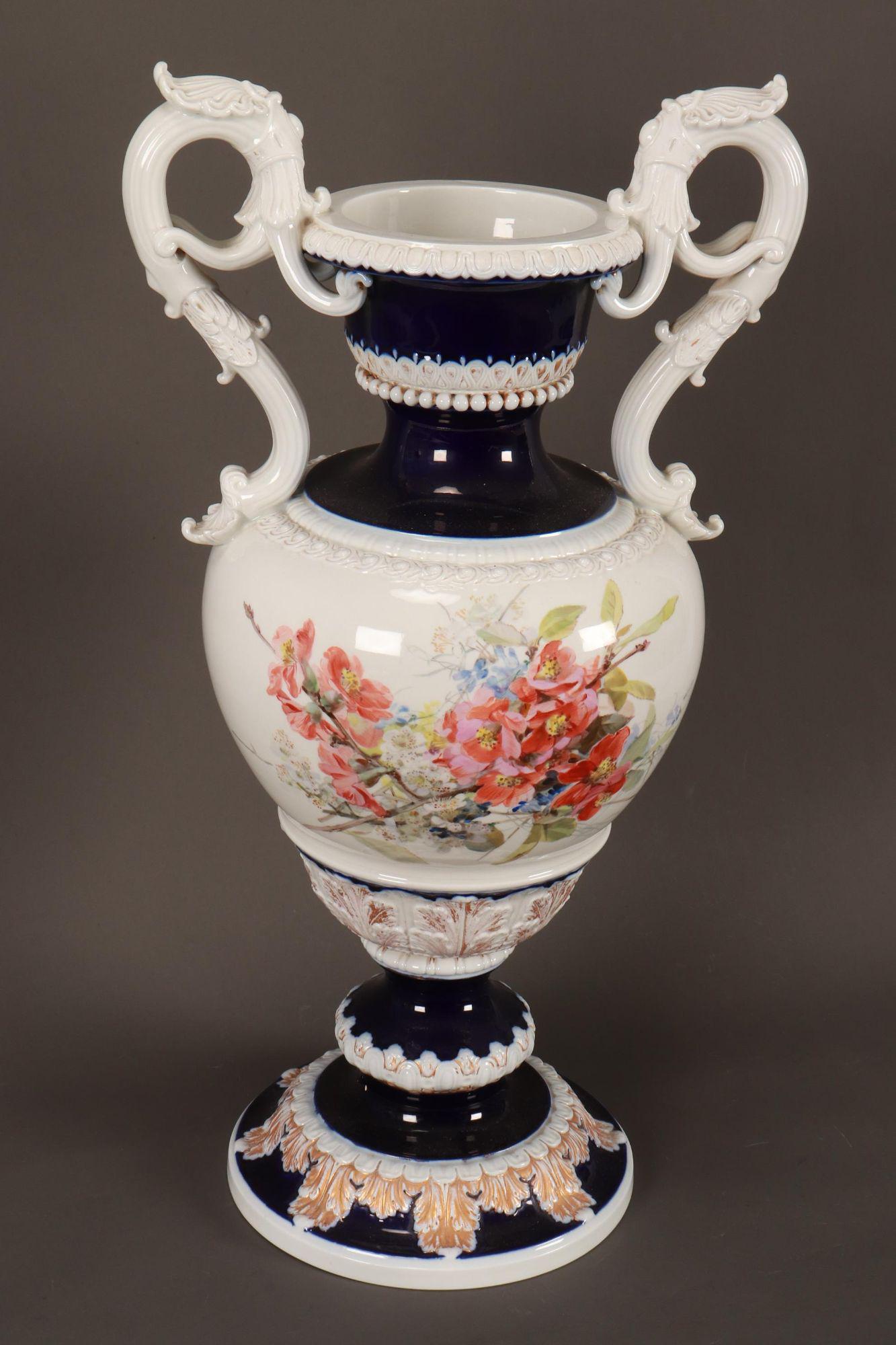 Large Meissen Twin Handled Porcelain Urn,: with large twin shell capped acanthus handles, the body hand painted to each side with flowers and foliage, the whole accented with acanthus and various decorative borders, raised on a circular foot, 
