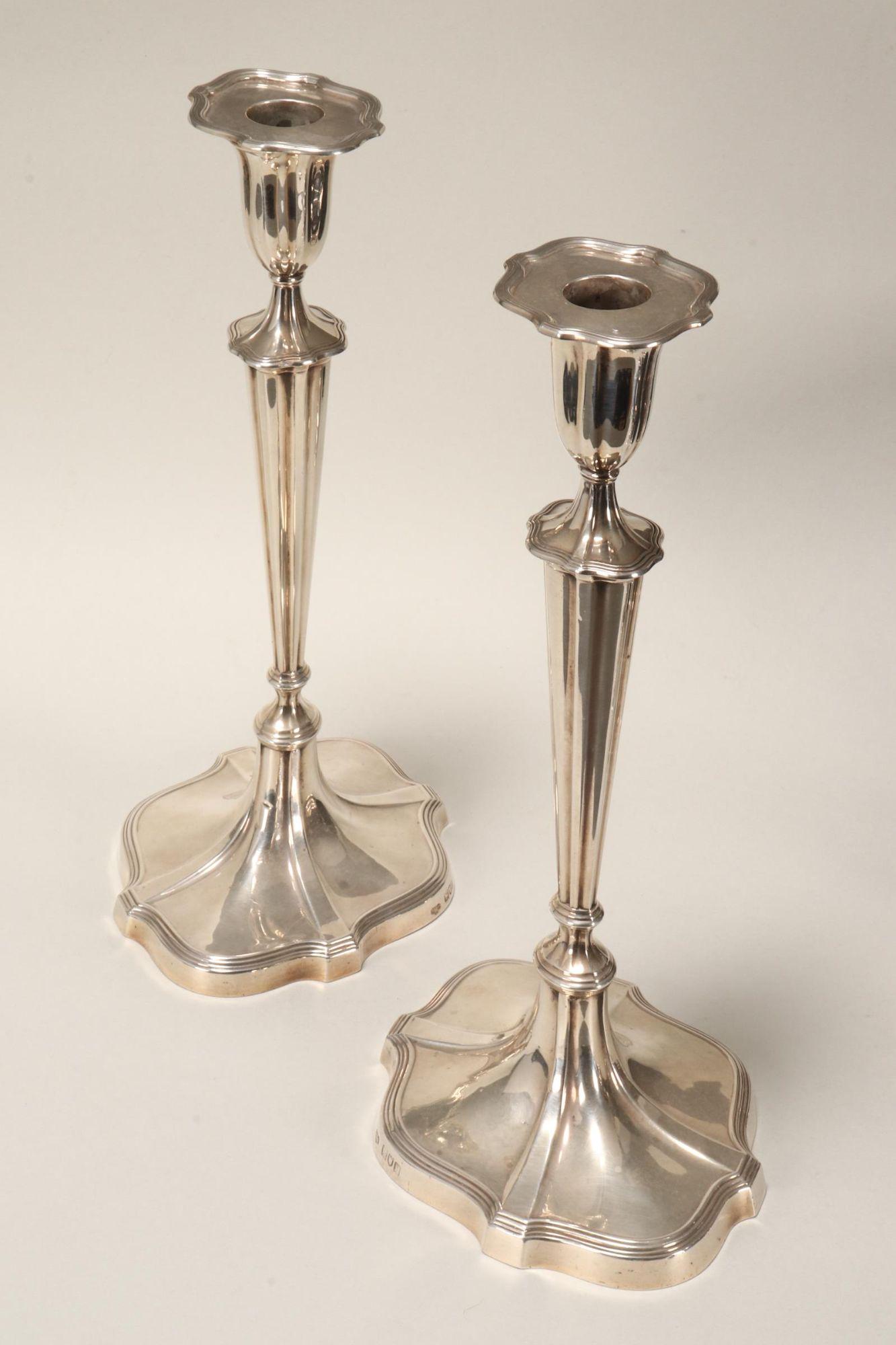 Pair of George V Sterling Silver Candlesticks,: hallmarked London, 1911, G&S Co.Ltd (Goldsmiths & Silversmiths Co Ltd), in Adam's style, with bell shaped capitals with flared rims set with hallmarked push fit sconces, the tapering knopped columns s