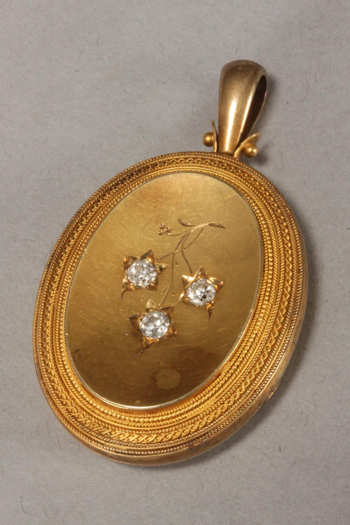 Victorian Gilt and Diamond Locket,: of oval form, the cover set with three large round cut diamonds in an engraved floral setting, all within an intricate filigree border, the verso engraved with the Irish shield of arms and initials, h