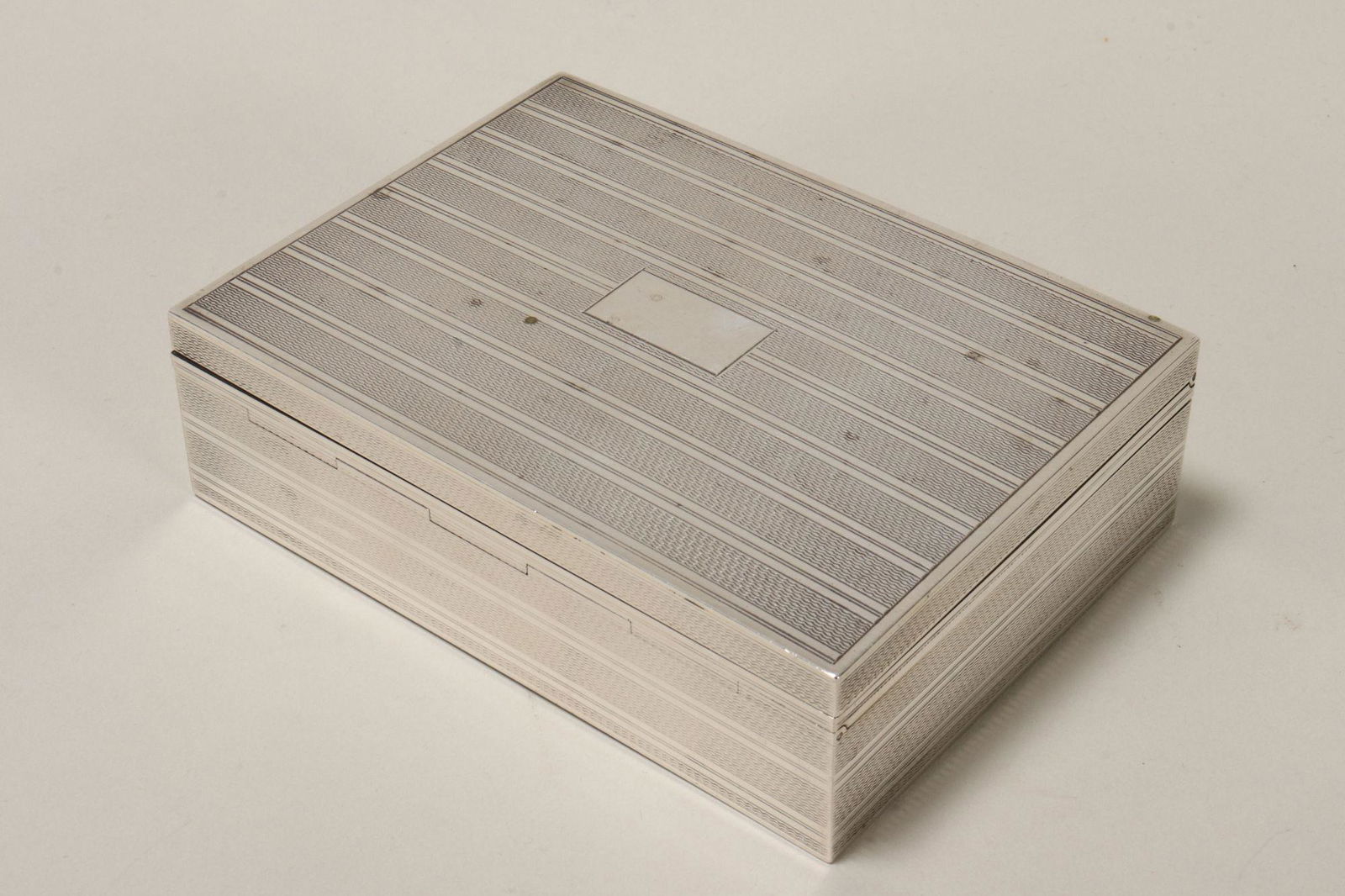 Silver Tobacco Box,: of rectangular form, with all over engine turned decoration, the hinged cover with central rectangular panel, a/f, weighted, 3.5cm x 12cm x 9cm