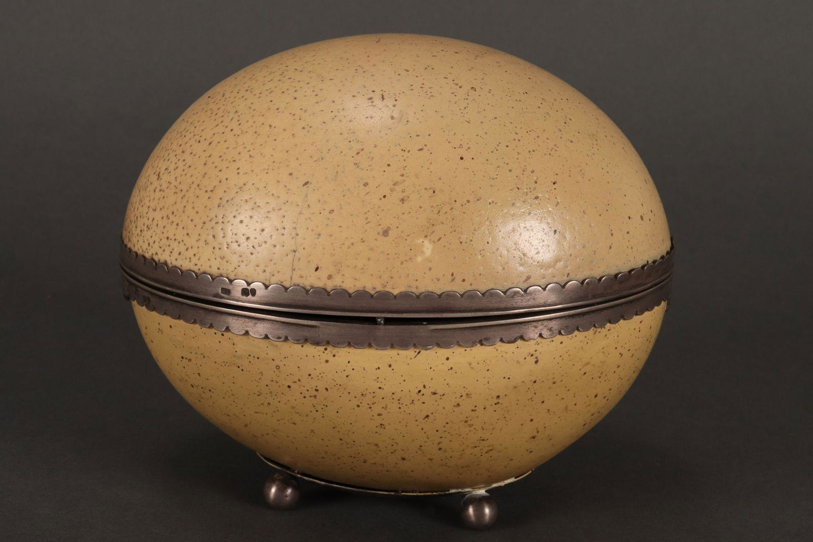 Victorian Sterling Silver Mounted Ostrich Egg,: hallmarked, London, 1894, S.C, in the natural form, with silver mounts and fitted velvet interior, the whole raised on four ball feet, length 17cm Provenance: The Edward Clark Collection, Melbourne