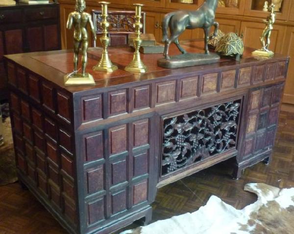 Chinese Rosewood & Elm Desk, c. 1950: with a rectangular top resting on banks of three graduated small drawers centered by a single long drawer resting on short square turned legs, w 152cms, d 75cms, h 79cm